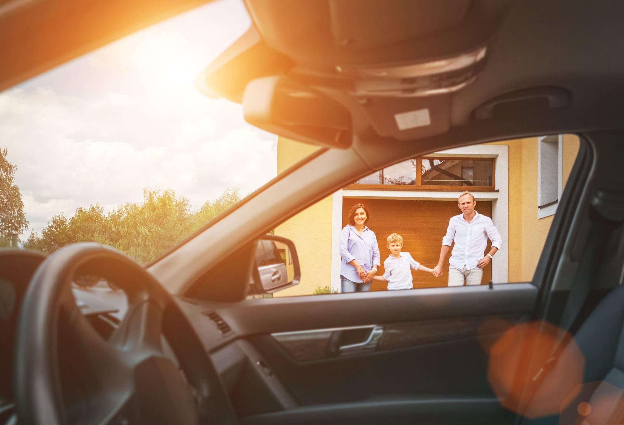 Young couple with little boy son goes to their car standing on t