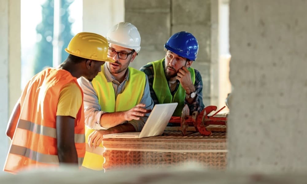 Controlling-Your-Workers-Compensation-Premium-Starts-With-Your-Experience-Modification-Rate-EMR-constrution-men-going-over-plans.